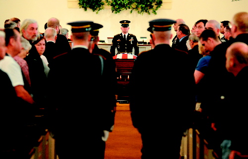 Maine National Guard honor guard detail prepare to carry the casket with the remains of Army Spc. Wade Slack out of the Blessed Hope Advent Christian Church in Waterville at the conclusion of his funeral Sunday. Slack, 21, specialized in disarming explosives and died of wounds suffered May 6 in indirect fire in Jaghatu, Afghanistan.
