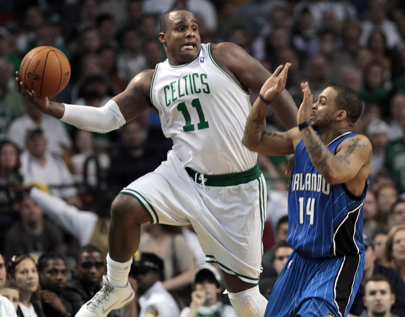 Boston Celtics forward Glen Davis saves the ball from going out of bounds as Orlando Magic guard Jameer Nelson reacts during the first half of Game 3 of the NBA Eastern Conference basketball finals in Boston on Saturday.