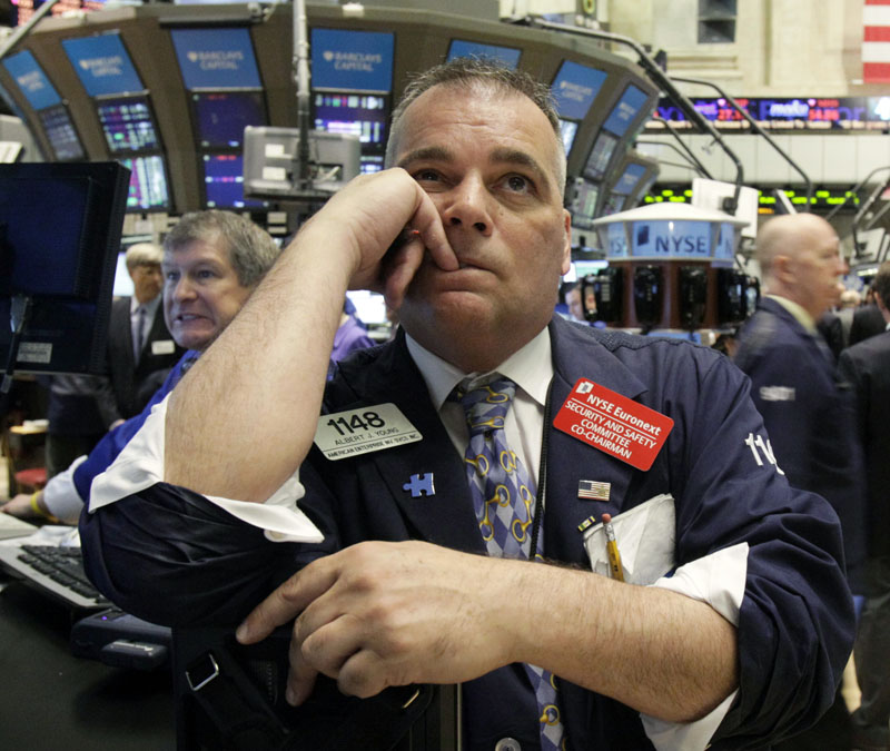 Trader Albert Young watches the numbers on the floor of the New York Stock Exchange today.