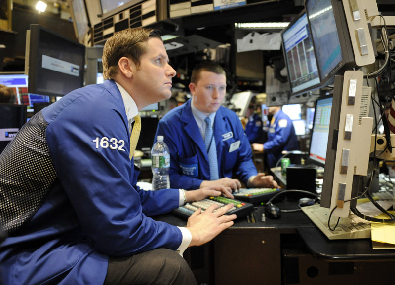 Traders work on the floor of the New York Stock Exchange today in New York.