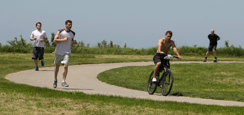 People enjoy the warm climate as they exercise on a path at Edgewater Park Monday in Cleveland. Northeast Ohio temperatures were in the 80's Monday and warm temperatures will continue throughout the week. An economist urged Maine business leaders to get behind federal climate change legislation.