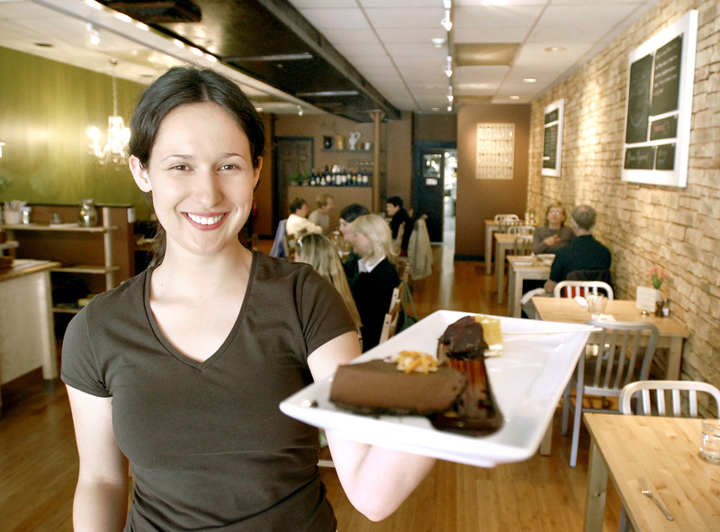 Katie Boone serves up a slice of the Green Elephant’s popular vegan chocolate orange mousse. The two eateries serve only vegetarian fare.
