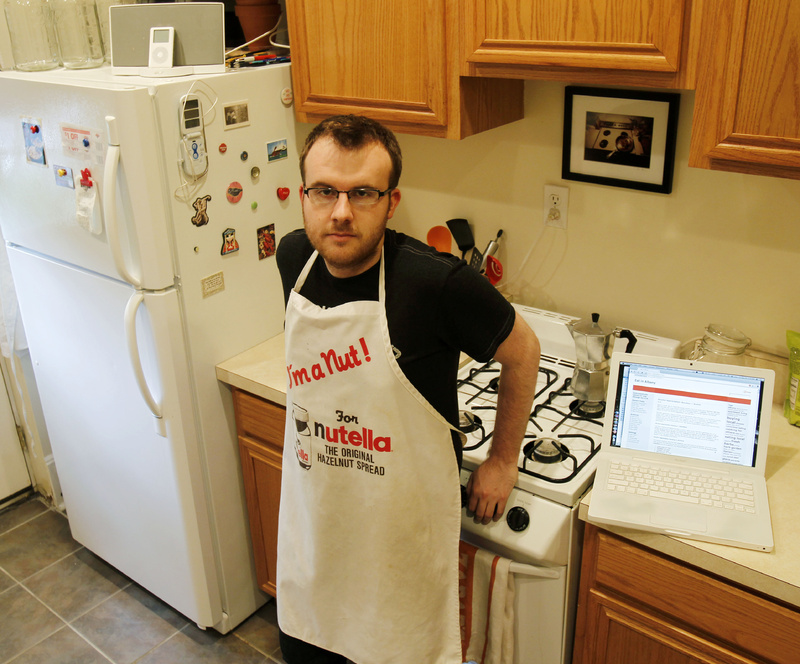 Brian Kraus, who posts a food blog, poses in his kitchen in Albany, N.Y. Kraus loves to cook but has only one cookbook.