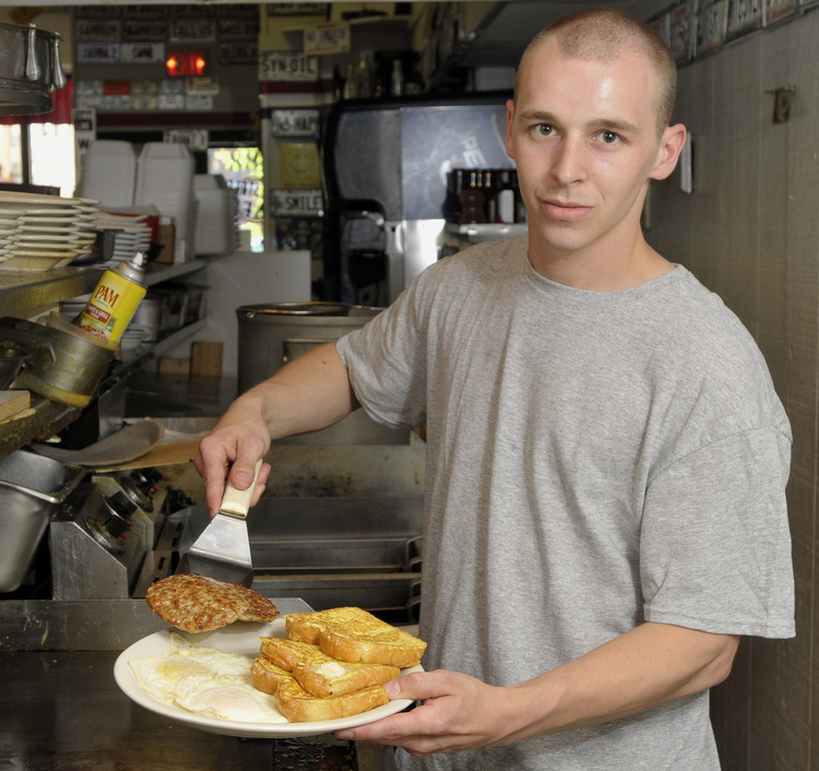 Rob Rollins, cook at the Main Street Cafe, serves up the Slammer, one of the popular breakfast dishes offered all day at the cafe in Westbrook.