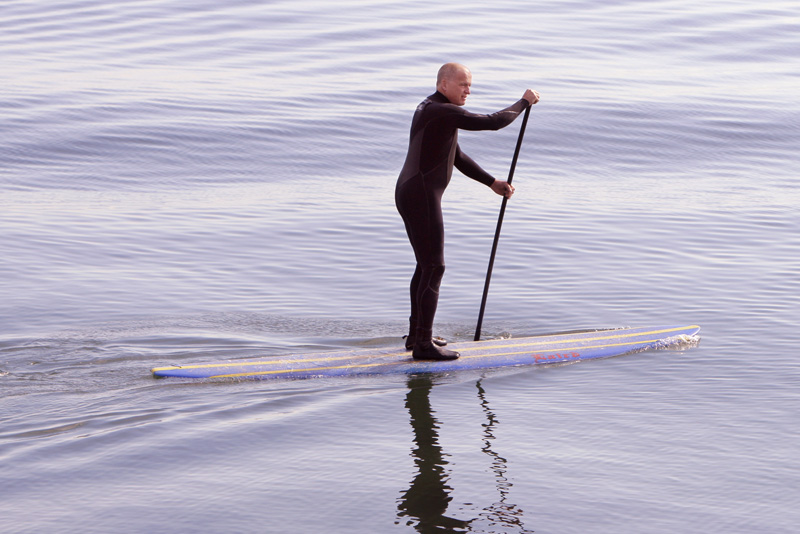 Mark Spaulding of Arundel paddles a paddleboard to East End Beach as part of a protest against offshore oil drilling.