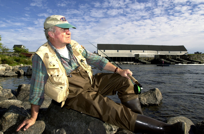 An angler takes a break at Upper Dam between Mooselookmeguntic and Upper Richardson lakes in this photo from 2002.