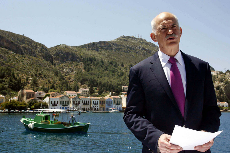 Greek Prime Minister George Papandreou announces Greece’s decision to request activation of a joint eurozone-International Monetary Fund financial rescue plan last month, from the main port of the remote southeast Greek Aegean island of Kastellorizo. Greece’s crisis raises fears that Portugal and Spain could be next.