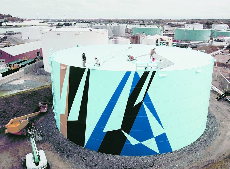 Workers paint the top of a tank last October at the Sprague Energy tank farm in South Portland. The project sends a sizable message about Maines commitment to creativity.