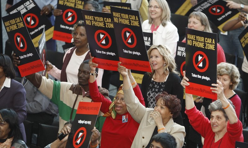 Supporters of of driving without cell phones hold placards during a rally in Detroit. Oprah Winfrey dedicated her Friday show to distracted driving and wants America’s drivers to declare their cars “No Phone Zones.”