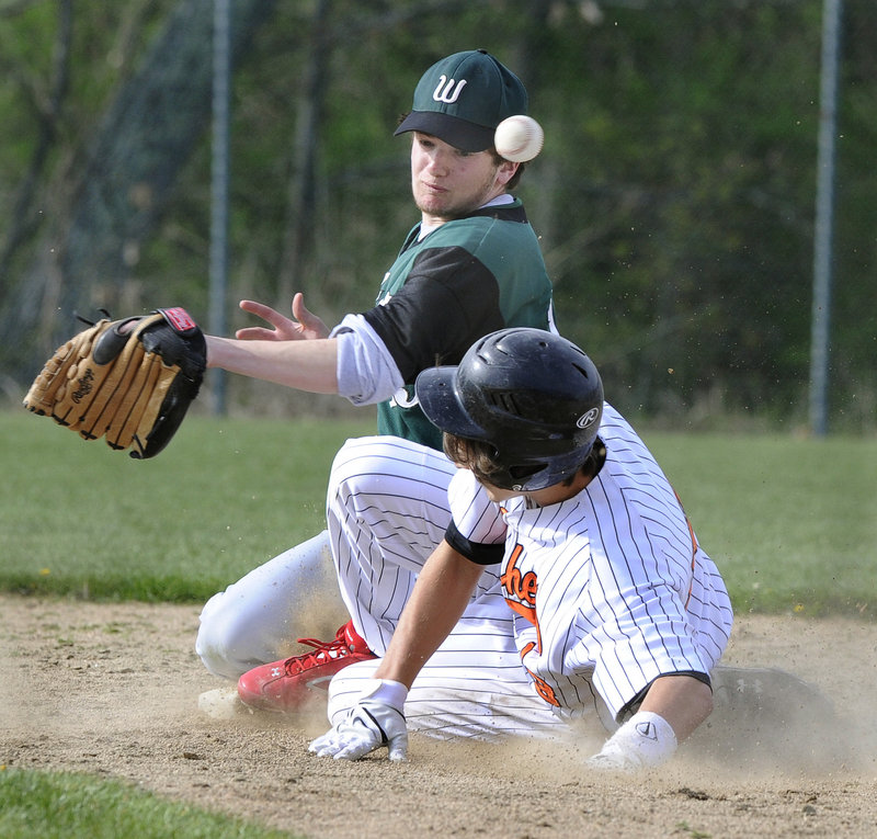 Eli Leavitt of North Yarmouth Academy steals second base Friday as the throw gets away from Noah Aronson of Waynflete during North Yarmouth Academy’s 13-2 victory in Portland. High Schools: D5-D6