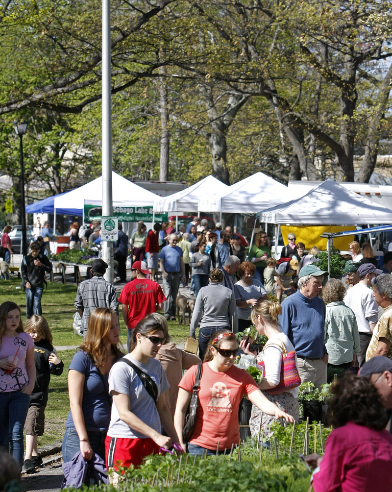 Crowds peruse the produce as the Portland Farmers Market opens for the season at Deering Oaks park on Saturday. The market made Travel + Leisure magazine’s 10-best list.