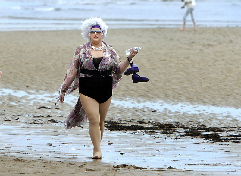 Drag queen "E,on," Benjamin Bernard of Lewiston, participates in the 5K run or walk for AIDS from Ogunquit Beach to Moody Beach and back, part of Ogunquit's Cinco de Mayo celebration. Finishing first was Bob Winn of Ogunquit, with a time of 17:14.