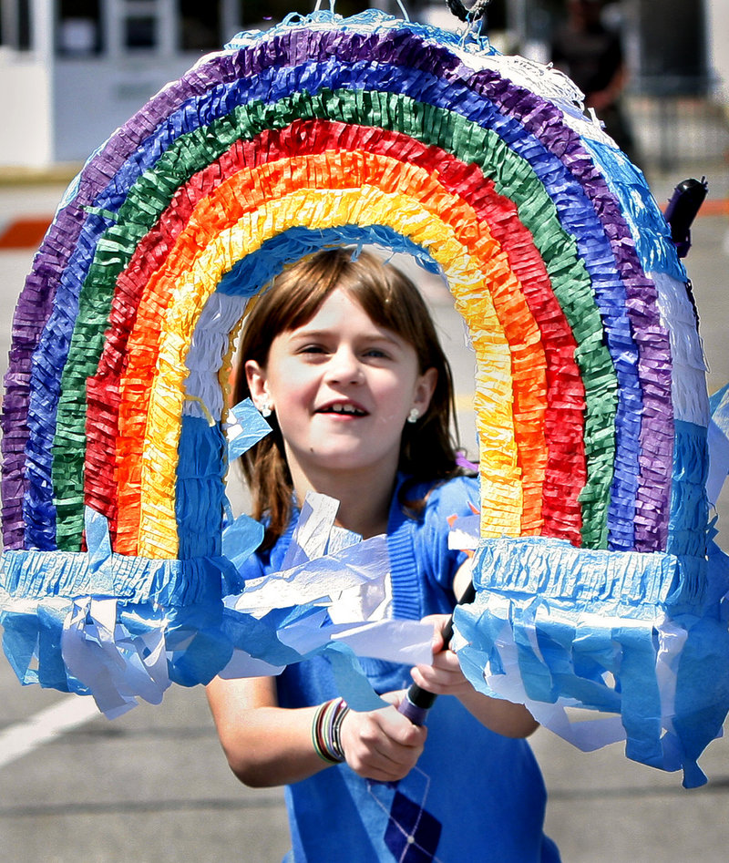 Morgan Sanderson, 8, of Concord, N.H., takes a swing at a pinata during Saturday's beach barbecue.
