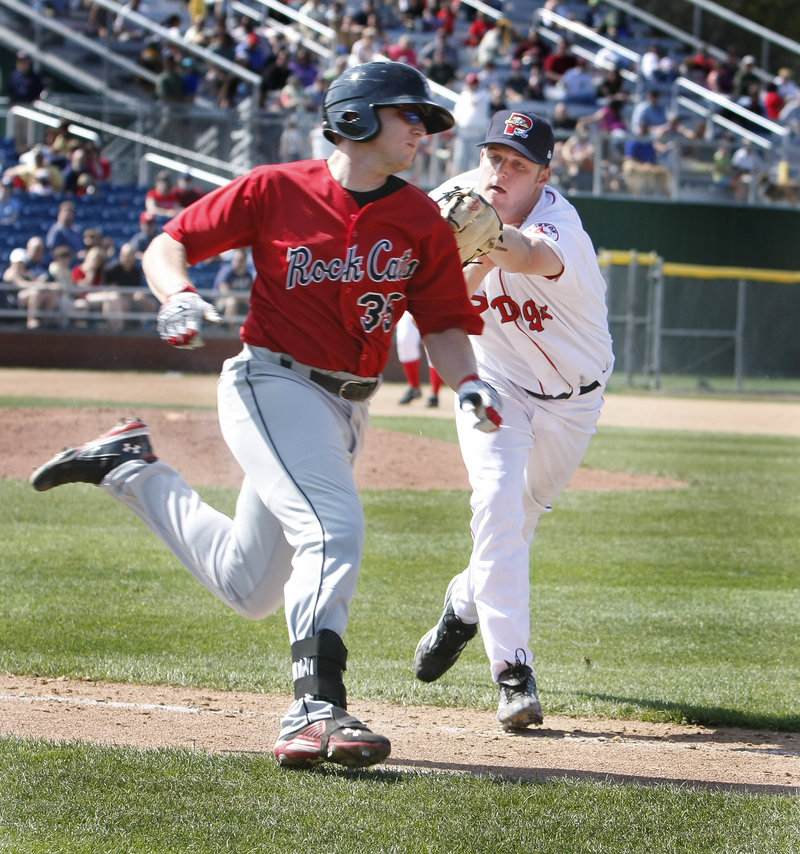 Sea Dogs pitcher T.J. Large tags out Chris Parmelee of the New Britain Rock Cats on the way to first base during Saturday's game at Hadlock Field. Large earned the win in relief of Felix Doubront.