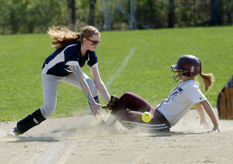 Abbie Hutchinson of Yarmouth reaches for the ball Saturday as Leigh Wyman of Freeport slides into third with a stolen base during Yarmouth's 9-2 victory in a Western Maine Conference softball game at Freeport.