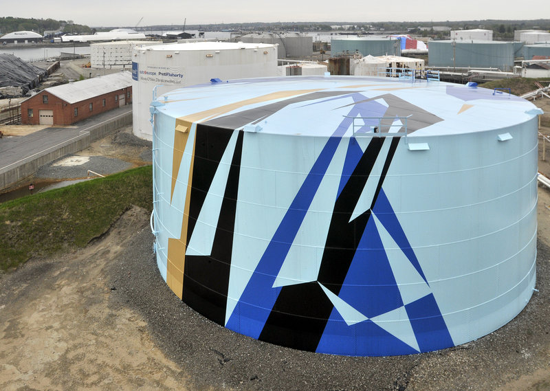 Artist Jaime Gili is visiting the Portland area for his first in-person look at the Sprague Energy oil tank in South Portland that was painted according to his design. Next up is the tank to the left rear.