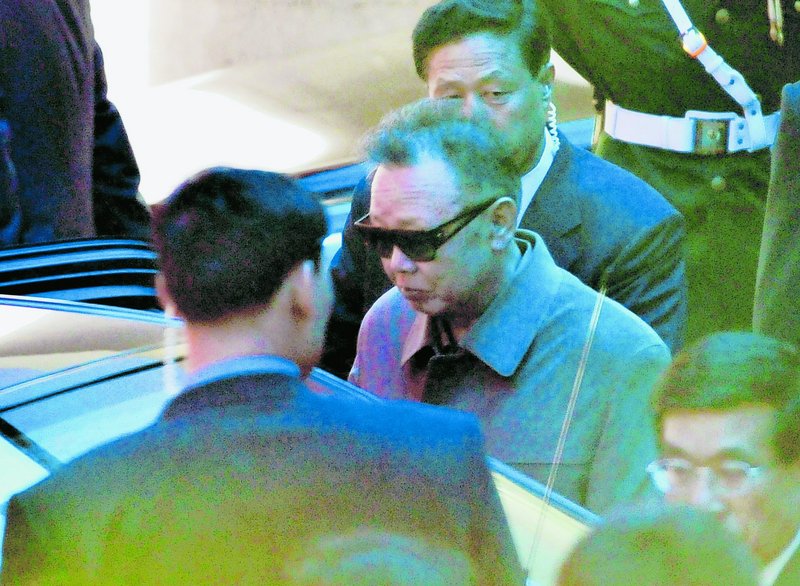 North Korean leader Kim Jong Il, wearing a pair of sunglasses, gets into a vehicle as he leaves a hotel in Dalian, China, on Monday.