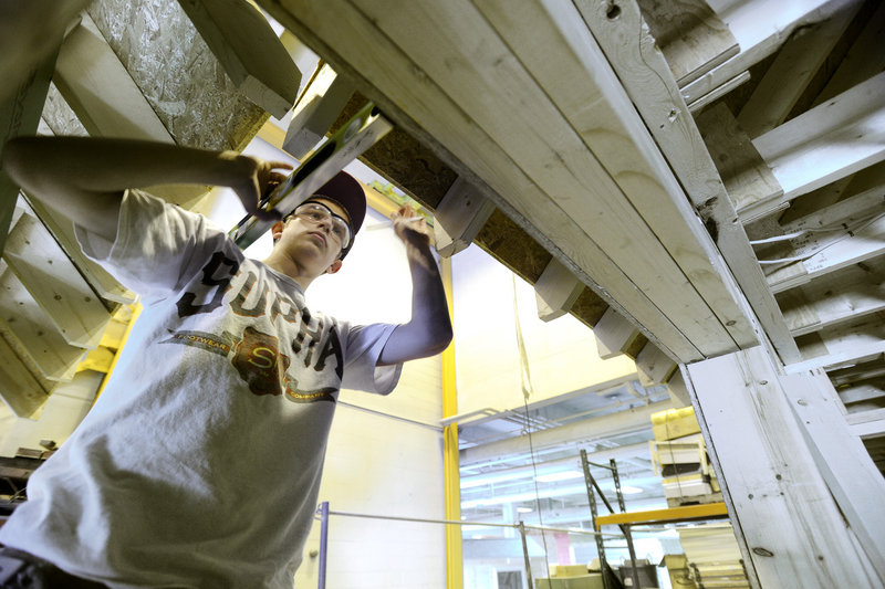 Student Nick Larrivee works Tuesday on a house soffit at PATHS in Portland, which serves about 515 students from 23 public and private schools and educational programs.