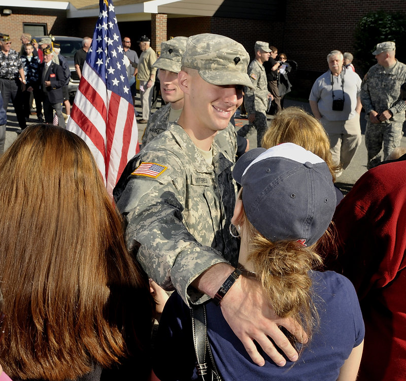 Spc. Tyson Butterfield of Saco gets a farewell hug and kiss from his fiancee, Katie-Jo Duran, after the official ceremony Wednesday in Saco. Their wedding is scheduled for Oct. 8, 2011.