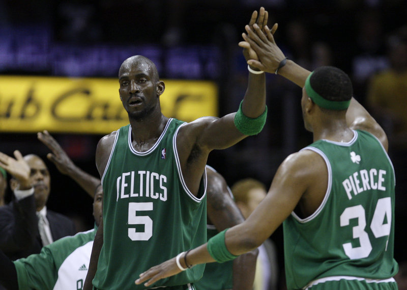 Kevin Garnett of the Boston Celtics, left, suffered a mild strain in the middle of his right foot late in the Game 2 victory Monday night against the Cleveland Cavaliers.