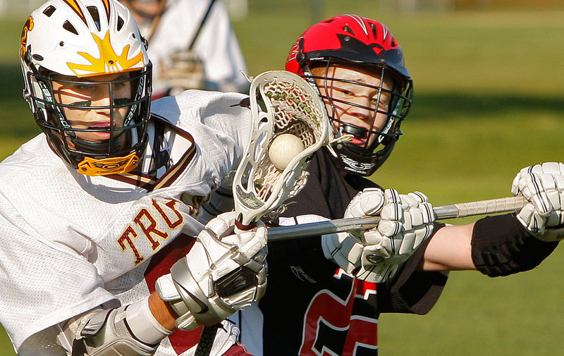 Peter Moore of Scarborough, right, attempts to dislodge the ball from Josh Cyr of Thornton Academy during their schoolboy lacrosse game Wednesday. Scarborough earned a 6-4 victory at Saco.
