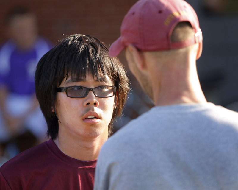 Yide “Clarence” Tan, talking with Coach Andrew Carlson, plays tennis for Thornton Academy. Tennis is popular with international students because they already know the sport.