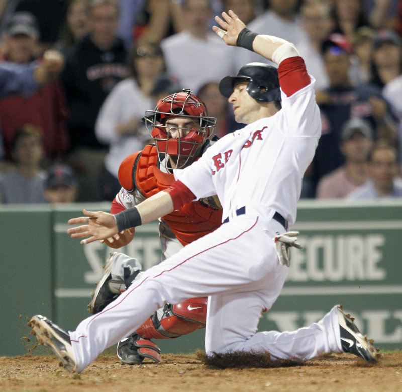 Marco Scutaro of the Boston Red Sox is cut down at the plate Wednesday night as catcher Mike Napoli of the Los Angeles Angels applies the tag. Scutaro was trying to score from second on a single to left by Kevin Youkilis in the seventh inning of Boston’s 3-1 victory at Fenway Park.