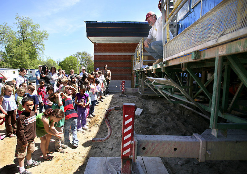 Delwin Berry of Maine Masonry demonstrates how a lift works Friday to Clifford Elementary School students at the new Ocean Avenue Elementary School in Portland. The students will be among those occupying the school when it opens.