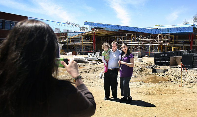 Julie Lannon photographs Will Leschey with his daughter Grace and her kindergarten teacher, Juanita DeWitt, during a tour of the new Ocean Avenue Elementary School in Portland on Friday.
