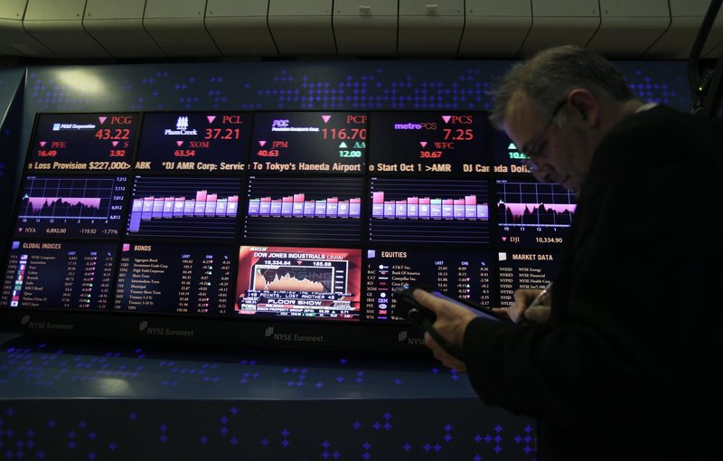 A trader works on his handheld device from the floor of the New York Stock Exchange on Friday as stocks continued to fall. The biggest U.S. fund managers say the recent bull market should weather Europe’s widening debt crisis.