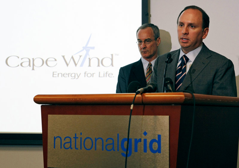 Tom King, right, president of National Grid, and Jim Gordon, president of Cape Wind, announce a deal between the two companies Friday in Waltham, Mass. National Grid has agreed to buy electricity from the nation’s first offshore wind farm, planned off Cape Cod.
