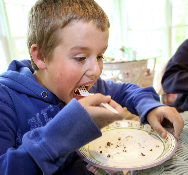 Joe Nadherny, 9, of Lincolnville finishes a piece of raspberry coconut cake on the sun porch of the Camden Maine Stay Inn.
