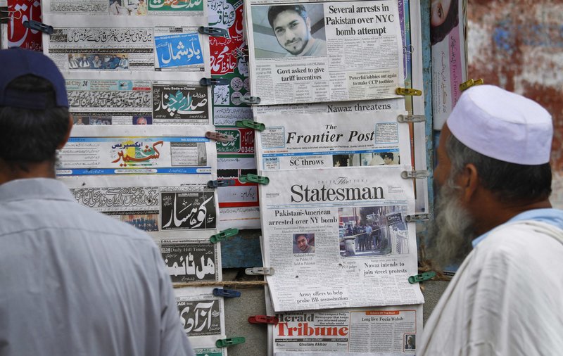 Pakistanis look at newspapers at a stall in Islamabad carrying headline stories on the arrest of a suspect in New York City’s Times Square bomb attempt. Islamabad has received a formal request for an investigation from the U.S.