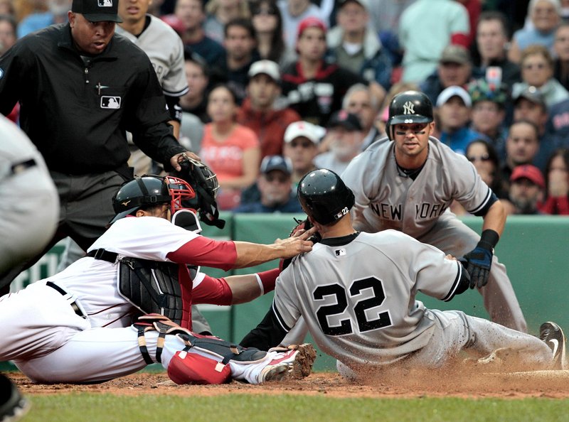 Randy Winn of the New York Yankees is cut down at the plate as Red Sox catcher Victor Martinez applies the tag Saturday. Turned out it didn’t matter much. Yankees 14, Red Sox 3.