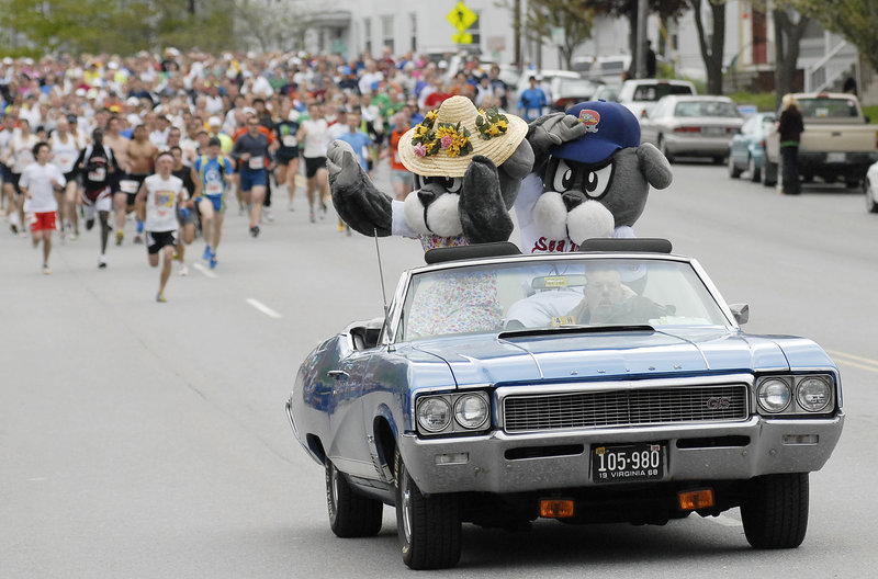 Sea Dogs mascot Slugger and his mom lead the way in the pace car at the start of the 10th annual Sea Dogs Mother’s Day 5K on Park Avenue in Portland on Sunday. Race proceeds benefit breast cancer research, and many of the runners ran to honor loved ones who died of the disease.