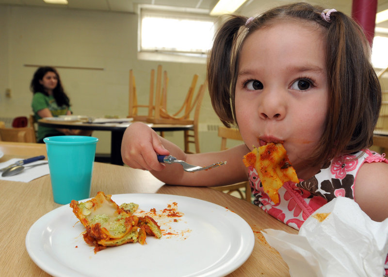 Avery Bennett, 3, enjoys vegetable pesto lasagna at an evening child-care program of Community Action Brattleboro Area. The meal is part of a federal pilot program to provide nutritious dinners to lower-income children.