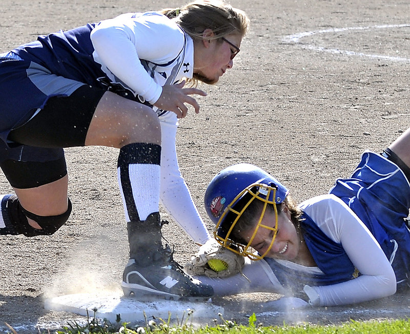 Poland third baseman Sara Sands tags out Falmouth's Alli Carver to complete a double play after a pop-up during their Western Maine Conference softball game in Falmouth. Falmouth won, 9-2.