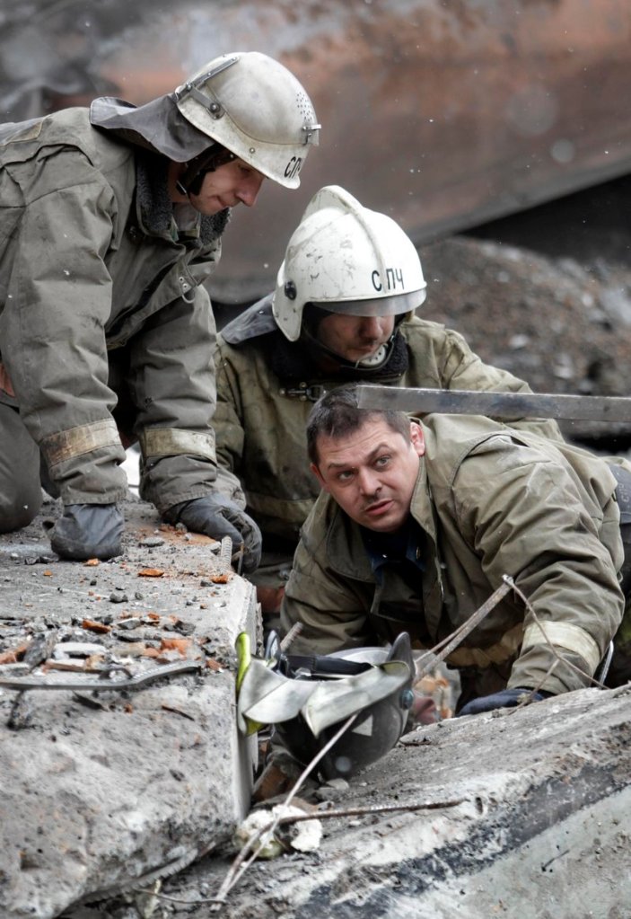 Emergency workers search the debris of the destroyed ventilation unit at the Raspadskaya mine in western Siberia on Tuesday. Two explosions tore through Russia’s largest underground coal mine on Saturday, killing 52 people. Methane is being blamed for the explosions.