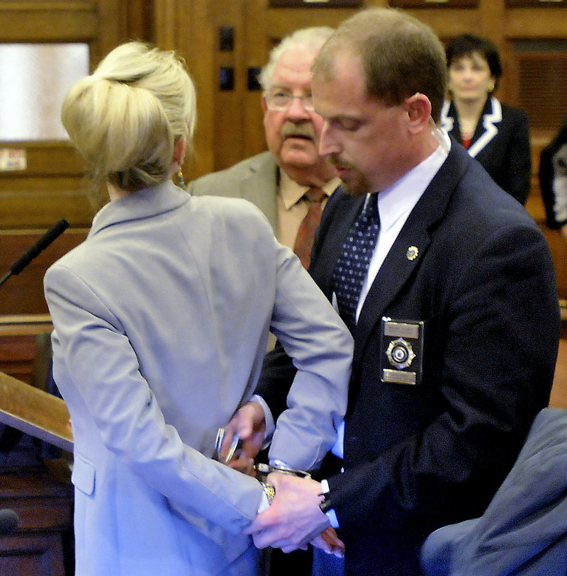 Bailiff Mike Gilbert handcuffs Linda Dolloff at the close of her attempted-murder trial Tuesday. Dolloff had her bail revoked after jurors found her guilty on all counts.