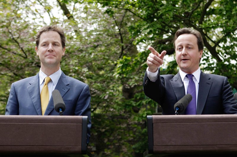 Prime Minister David Cameron, right, and Deputy Prime Minister Nick Clegg hold their first joint news conference Wednesday in the garden of 10 Downing St. “This is what the new politics looks like,” Clegg said.