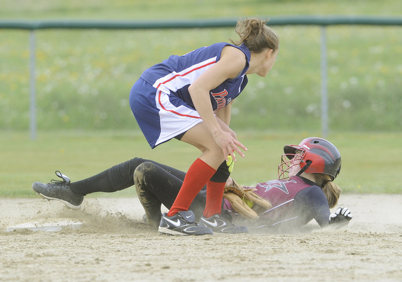 Katie Whittum of Greely slides safely into second with a stolen base Wednesday as shortstop Rachel Edson of Gray-New Gloucester applies the tag. Greely, which had been scrambling for a Western Class B tournament spot, earned a 9-7 victory at home.