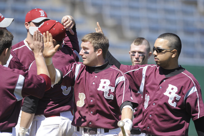 Reggie Smith, 3, celebrates with teammates Thursday after scoring for Briarcliffe, which beat Cincinnati Clermont in the USCAA final as baseball returned to The Barkpark in OOB.