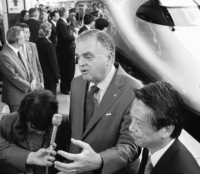 Standing by bullet trains, U.S. Transportation Secretary Ray LaHood, center, with Satoshi Seino, president of East Japan Railway Co., talk with reporters during LaHood’s inspection of Japan’s high-speed train operations in Tokyo Wednesday.