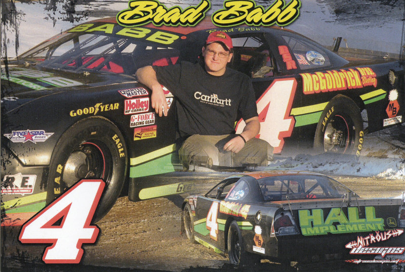 Brad Babb poses next to his No. 4 race car for a promotional photo. He's the third Babb to drive the No. 4, following in the footsteps of his father, Bobby, and grandfather Robert Babb Sr.