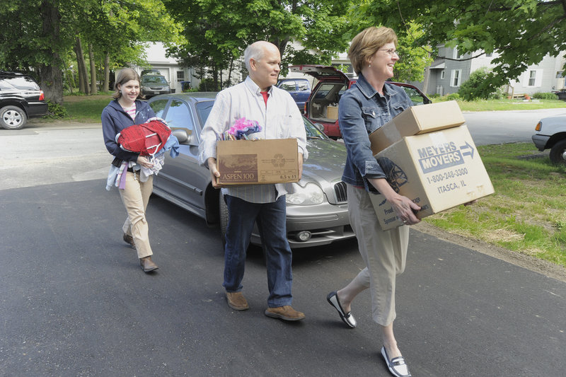 Anna Bulger, left, gets some help with her belongings Saturday from her parents Mary Chris and Paul Bulger. Anna and seven others this weekend are moving into a nine-bedroom, renovated home in South Portland.
