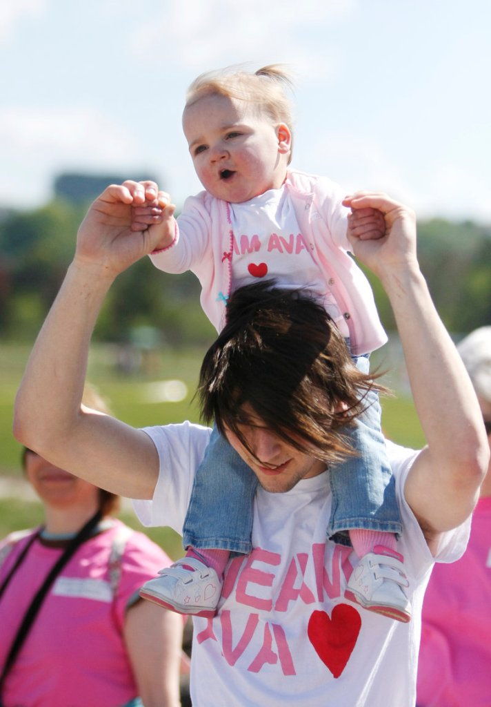 Ava Allen, 17 months, of Waterville sits atop the shoulders of her dad, Ben, while walking with their family – dubbed Team Ava – during the Southern Maine Heart Walk in Portland on Sunday. Ava, who has a heart defect, has had three open-heart surgeries with another to follow. Funds raised from the walk will benefit the American Heart Association.