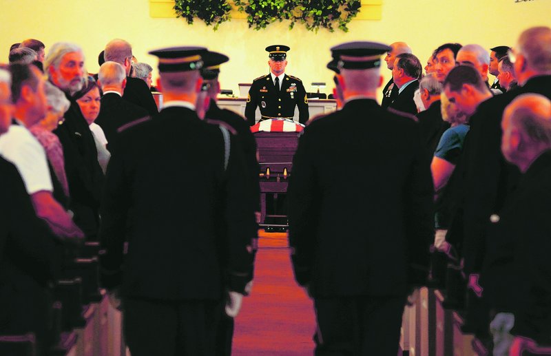 A Maine Army National Guard honor guard detail prepares to carry the casket with the remains of Army Spc. Wade Slack out of the Blessed Hope Advent Christian Church in Waterville at the conclusion of his funeral Sunday.