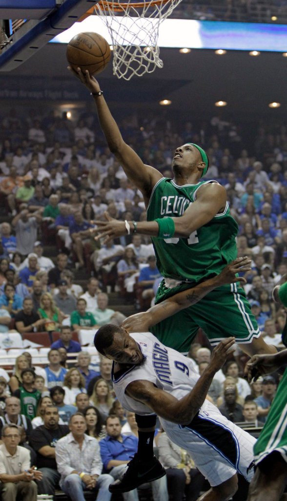 Paul Pierce of the Celtics is called for an offensive foul as he knocks Rashard Lewis of the Magic to the floor while driving to the basket on Sunday afternoon.
