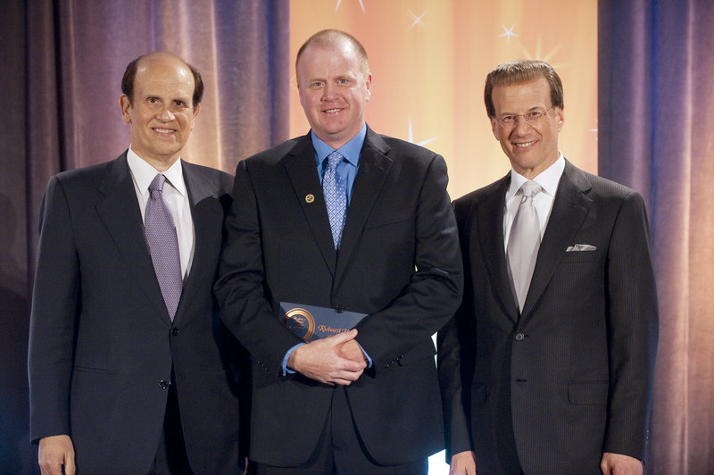 Milken Family Foundation co-founder Michael Milken, left, and foundation Chairman Lowell Milken, right, stand with The REAL School’s Richard Meserve at the recognition ceremony Saturday in Santa Monica.