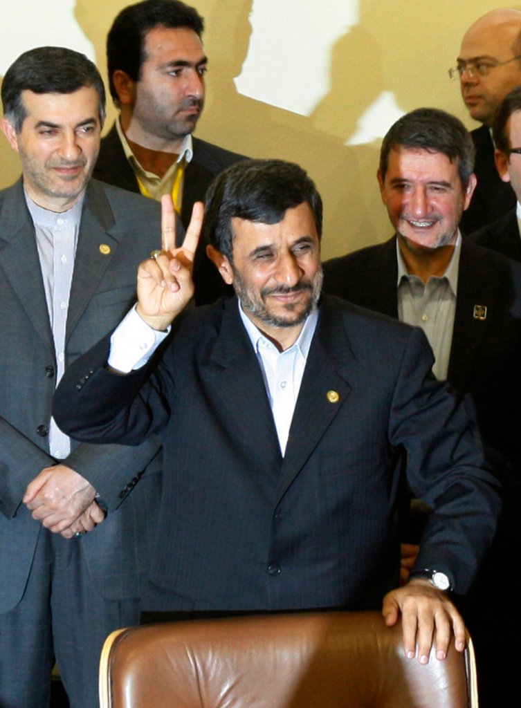 Iranian President Mahmoud Ahmadinejad flashes a victory sign Monday in Tehran before signing a pact to ship much of Iran’s enriched uranium to Turkey.
